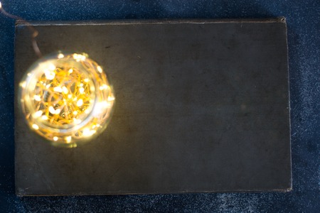 Dark background of an old book on a matte background with lightsの写真素材