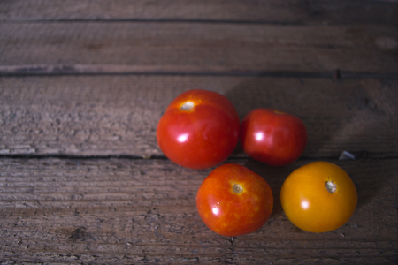 Fresh tomatoes on a wooden old backgroundの写真素材