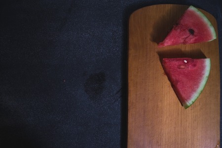 Sliced slices of watermelon on a dark backgroundの写真素材