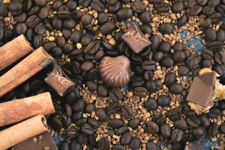 Sweet still life. Coffee beans, chocolate bars and cinnamon sticks