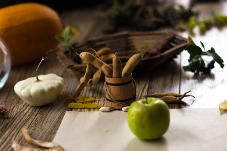 A green apple on a white sheet on a wooden backgroundの写真素材