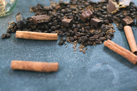 Sweet still life. Coffee beans, chocolate bars and cinnamon sticksの写真素材