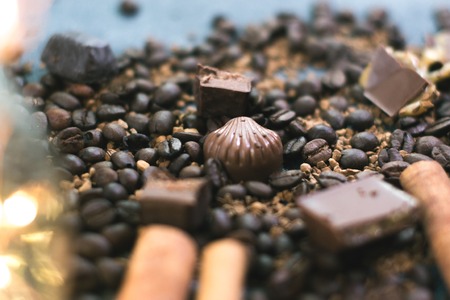 Sweet still life. Coffee beans, chocolate bars and cinnamon sticksの写真素材
