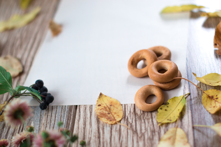 Bagels on a sheet of paper on a wooden backgroundの写真素材