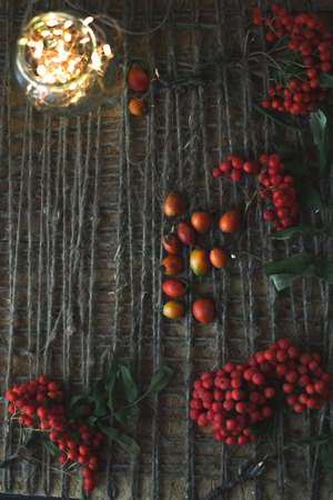 Rowan on a wooden background with a twineの写真素材