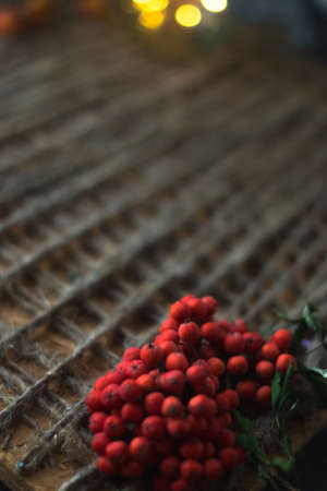 Rowan on a wooden background with a twineの写真素材