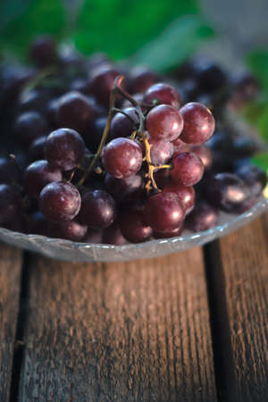 Ripe grapes on a wooden old background