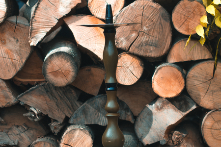Hookah on a wooden background in the autumn afternoon