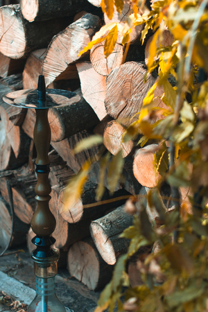Hookah on a wooden background in the autumn afternoonの写真素材