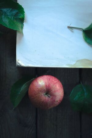 Apples with a book on a wooden backgroundの写真素材