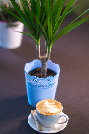 A cup of coffee with a picture in a cafeの写真素材