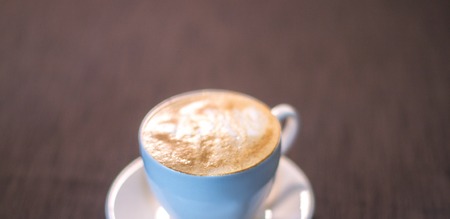 A cup of coffee with a picture in a cafeの写真素材