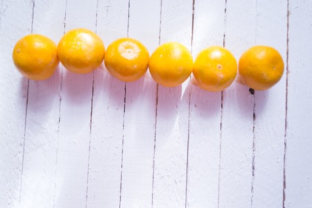 Fresh tangerines on a white wooden backgroundの写真素材