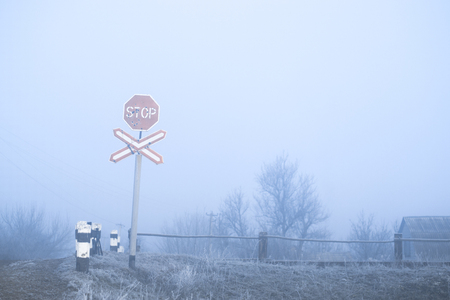 Road sign in the frost in the winter frosty morning near the railwayの写真素材