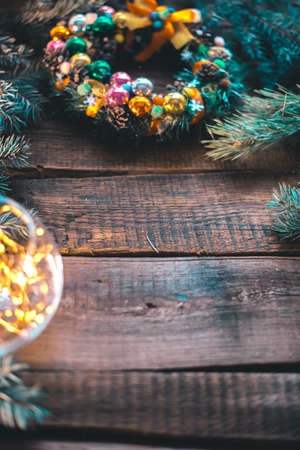 New Year's still-life. Christmas tree branches and ornaments on a wooden background.の写真素材