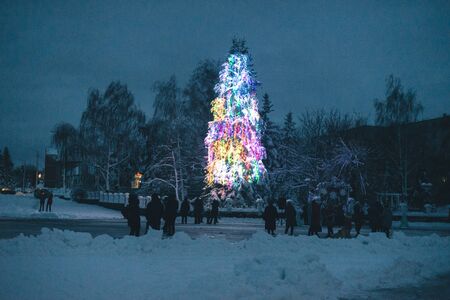 New Year tree in garlands in winter in the townの写真素材