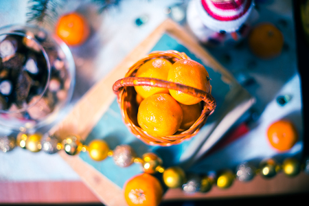 Mandarins in a small basket on a pile of booksの写真素材
