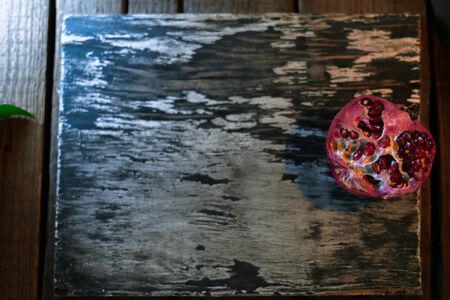 Garnet on a dark wooden board with a blurred backgroundの写真素材