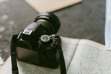 Camera on a black matte background with a blurred background.の写真素材