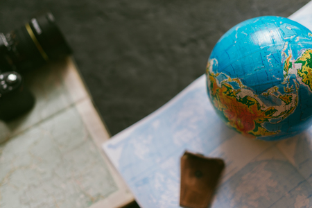 The concept of travel. Map and globe on a black matte backgroundの写真素材