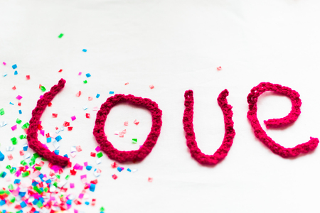 Inscription in knitted letters on a white background. St. Valentine's Day isolate.の写真素材