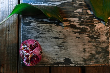 Garnet on a dark wooden old background. Still lifeの写真素材