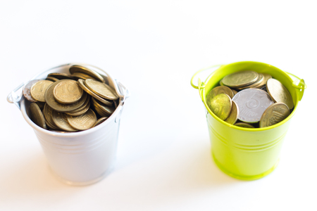 A bucket with coins on a white background is isolate. Business concept.の写真素材