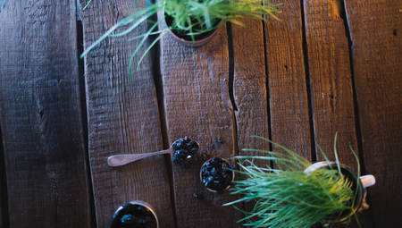 Still life of grapes and prunes on a wooden backgroundの写真素材
