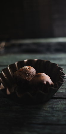 Cupcakes on a dark wooden background in an iron dishの写真素材