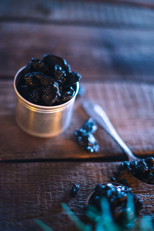 Still life of grapes and prunes on a wooden backgroundの写真素材