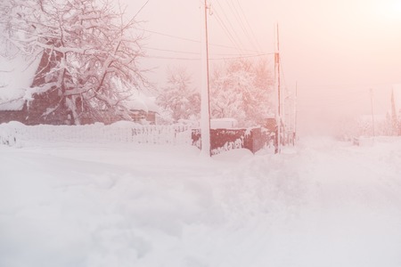 Winter snowfall in the village. Snowy collapse.の写真素材