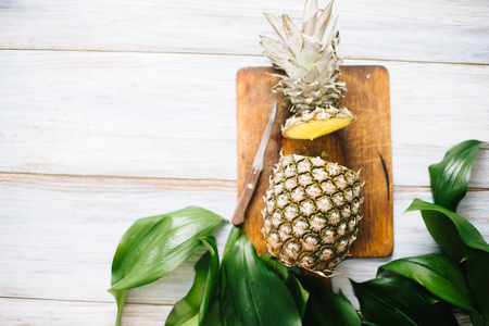 Ripe bisected ripe pineapple on a wooden background.の写真素材
