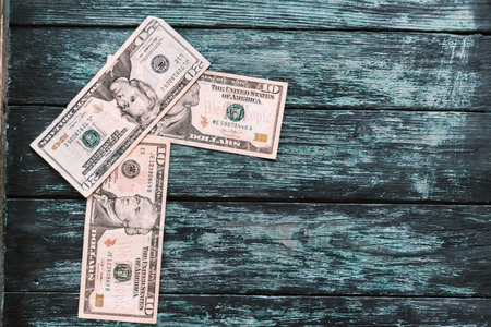 American dollars on a green wooden background.の写真素材