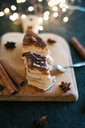 Cake on a wooden tray on a black matte background.の写真素材
