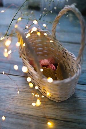 Marshmallow in a basket with a horn with garlands.の写真素材