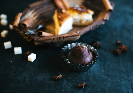 Cake on a wooden tray on a black matte background.の写真素材