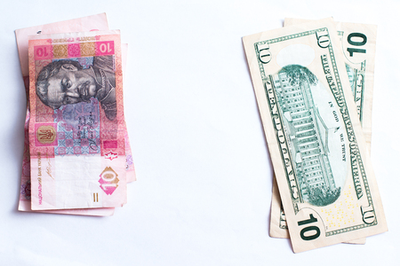 American dollars and Ukrainian hryvnia on a white background isolates.の写真素材