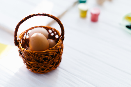 Hands are stacked in the heart against the background of the Easter still life.の写真素材