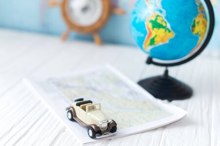 Small car on the map. The concept of travel.の写真素材