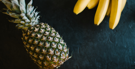 Pineapple on a black matte cement background.の写真素材