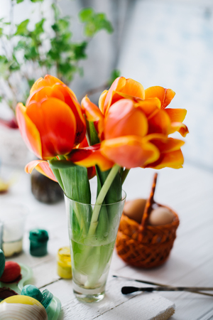 Blossoming red tulips on a white wooden background.の写真素材