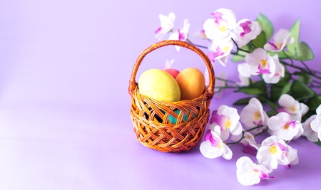 Easter eggs in a basket on a wooden background.の写真素材