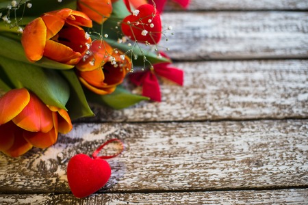 Tulips flowers on an old wooden background.の写真素材