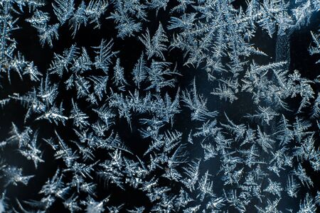 Frosty patterns on the frozen window are macro. Winter background.の写真素材