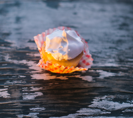 Cupcakes on a wooden background in the sunlight.の写真素材