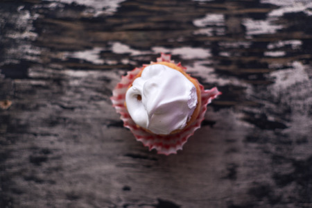 Cupcakes with white cream on a wooden background.の写真素材