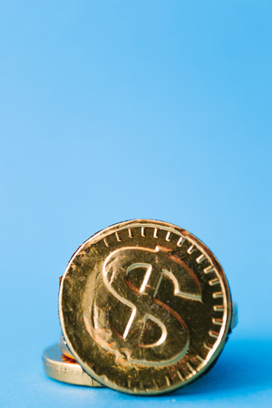 Gold dollar on a blue background. Concept of currencies.の写真素材