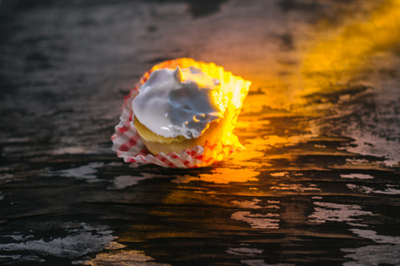 Cupcakes on a wooden background in the sunlight.