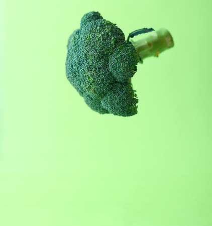 Broccoli in the air on a green background.の写真素材