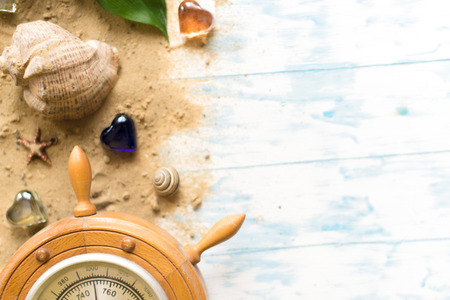 Barometer with shell in the sand on a wooden background.の写真素材